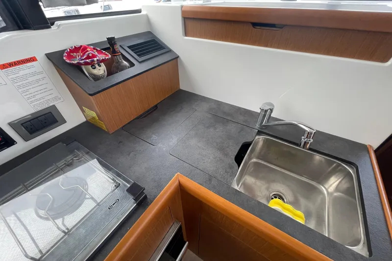 Slide: The Image of 2018 Beneteau Swift Trawler 35 kitchen area with sink and countertop. - 43