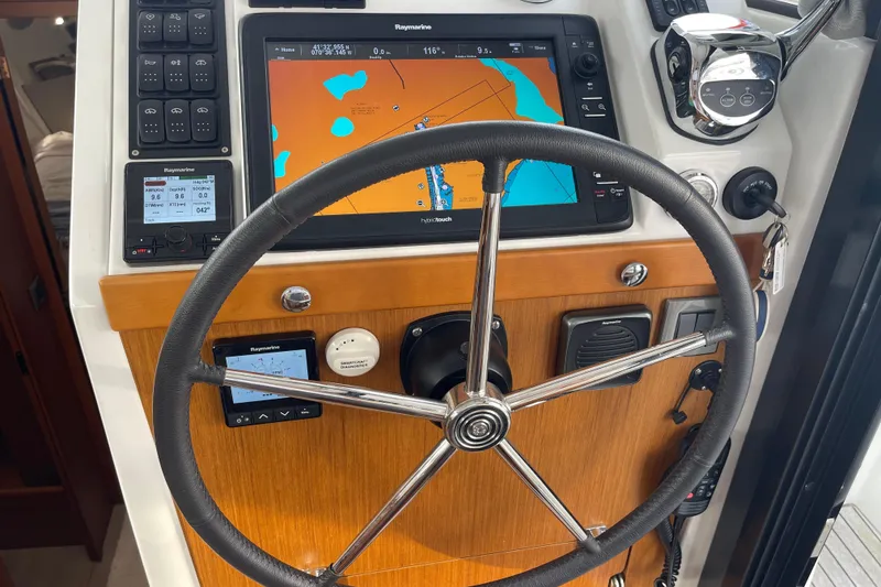 Slide: The Image of Steering wheel and navigation system of 2018 Beneteau Swift Trawler 35 boat. - 53