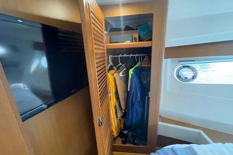 Slide: The Image of Interior of 2018 Beneteau Swift Trawler 35 with open closet and TV. - 63