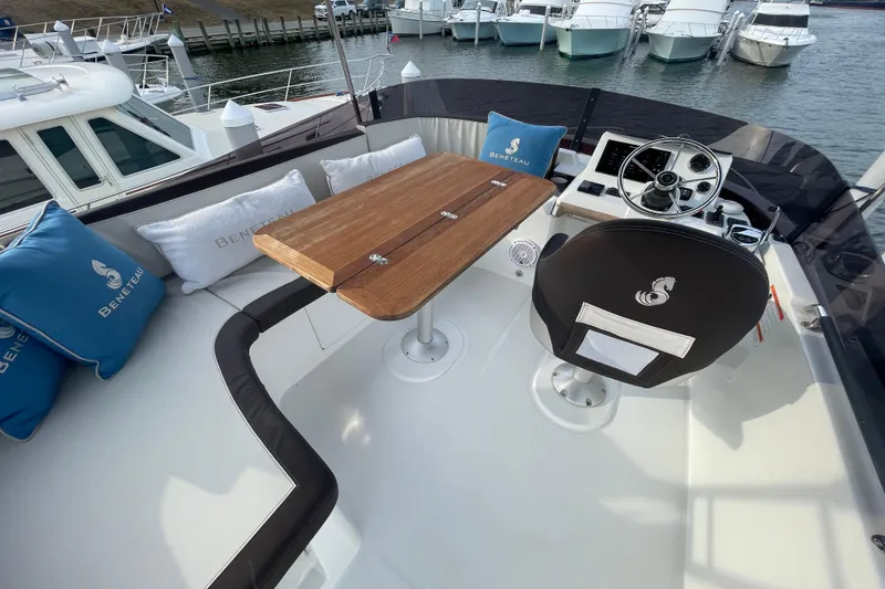 Slide: The Image of 2018 Beneteau Swift Trawler 35 flybridge with seating, table, and helm station. - 81