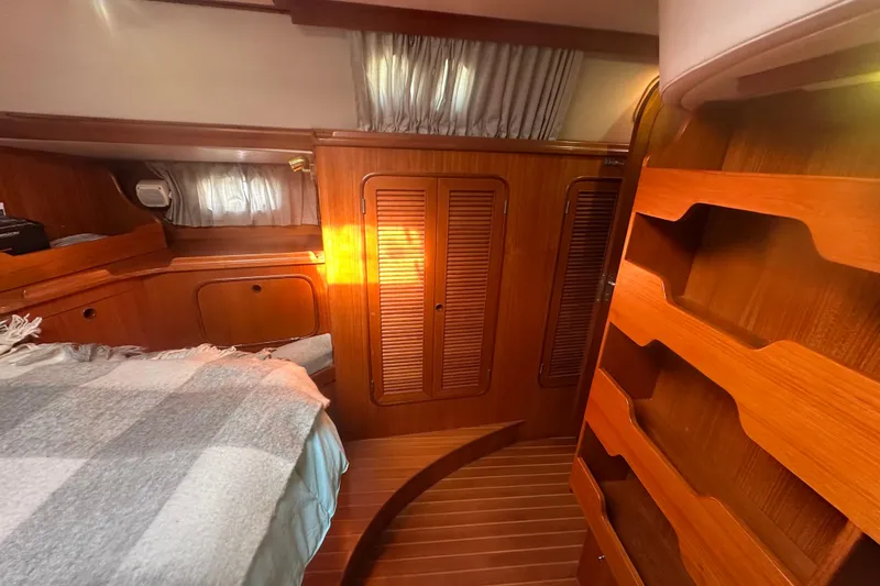 Slide: The Image of Cozy 1991 Taswell Sloop cabin interior with wooden finishes and soft lighting. - 10
