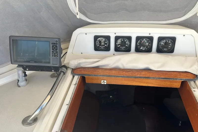 Slide: The Image of 1991 Taswell Sloop cockpit with navigation instruments and gauges. - 12