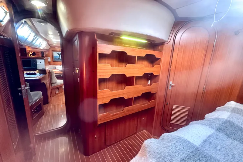 Slide: The Image of Interior of 1991 Taswell Sloop yacht with wooden cabinetry and cozy seating area. - 13