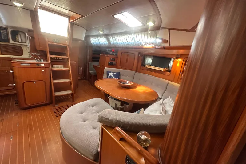 Slide: The Image of Interior of 1991 Taswell Sloop featuring cozy seating and wooden finishes. - 20