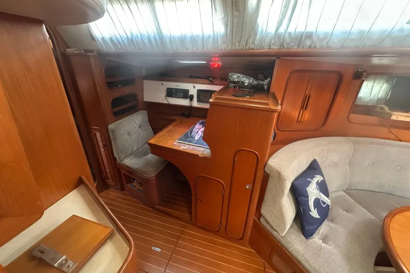 Slide: The Image of Interior of 1991 Taswell Sloop with wooden finish and cozy seating area. - 21