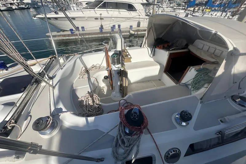 Slide: The Image of 1991 Taswell Sloop sailboat cockpit with ropes and steering wheel, docked at marina. - 23