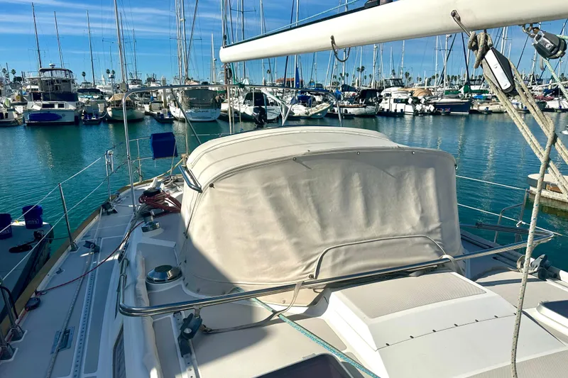 Slide: The Image of 1991 Taswell Sloop docked in a marina, surrounded by various boats under a clear blue sky. - 24