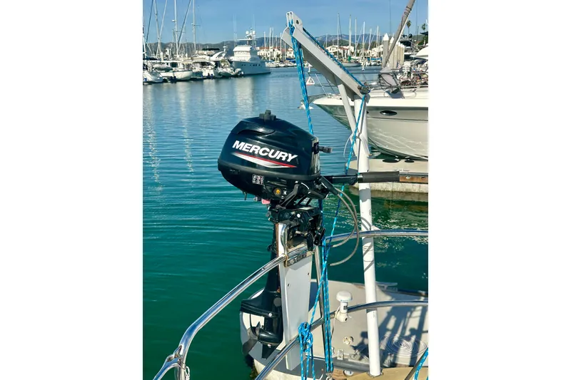 Slide: The Image of 1991 Taswell Sloop with Mercury outboard motor in marina setting. - 27