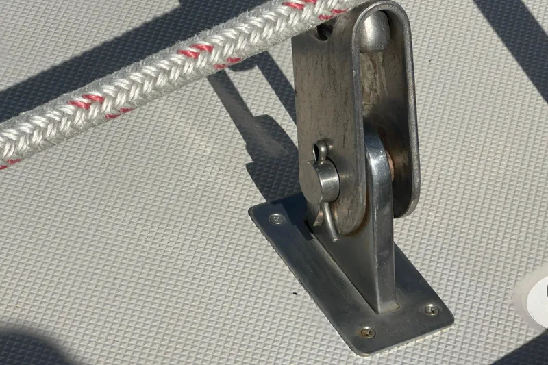 Slide: The Image of Close-up of a 1991 Taswell Sloop deck fitting with rope and pulley. - 32