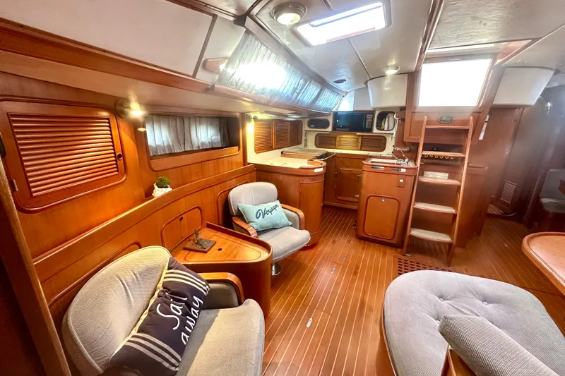 Slide: The Image of Luxurious 1991 Taswell Sloop interior with elegant wood finish and cozy seating area. - 4