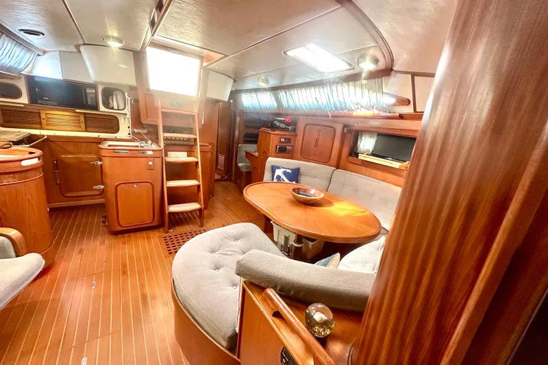 Slide: The Image of Luxurious 1991 Taswell Sloop interior with wooden finishes and cozy seating area. - 5