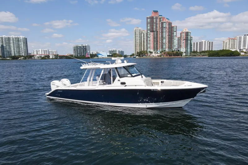 The Image of 2022 Pursuit S 358 Sport boat on water with city skyline background. - 0