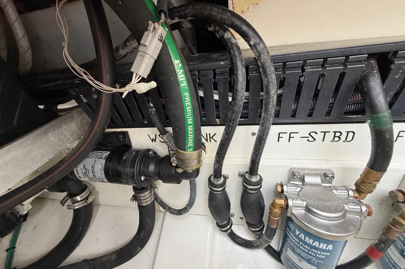 Slide: The Image of Engine compartment of 2022 Pursuit S 358 Sport with marine hoses and Yamaha fuel filter. - 104