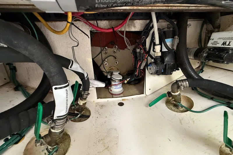 Slide: The Image of Engine compartment of 2022 Pursuit S 358 Sport boat, showing hoses and wiring. - 106