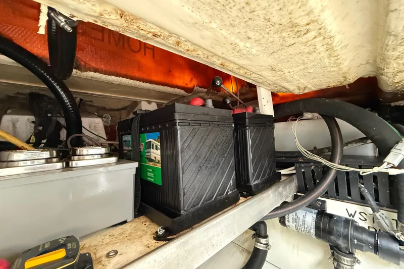 Slide: The Image of Battery compartment of 2022 Pursuit S 358 Sport boat, showing wiring and components. - 107