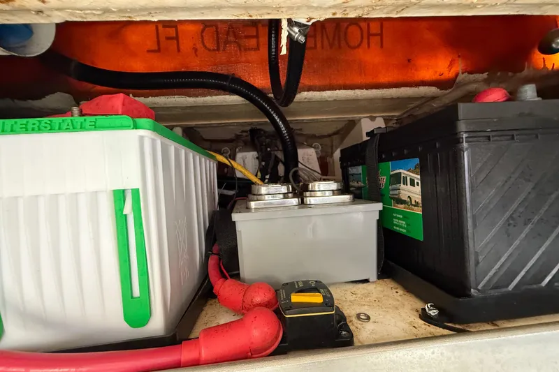 Slide: The Image of Battery compartment of 2022 Pursuit S 358 Sport with wiring and components. - 108