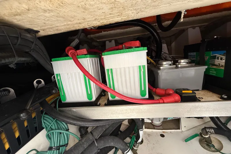 Slide: The Image of Battery compartment of a 2022 Pursuit S 358 Sport boat, featuring Interstate batteries. - 109