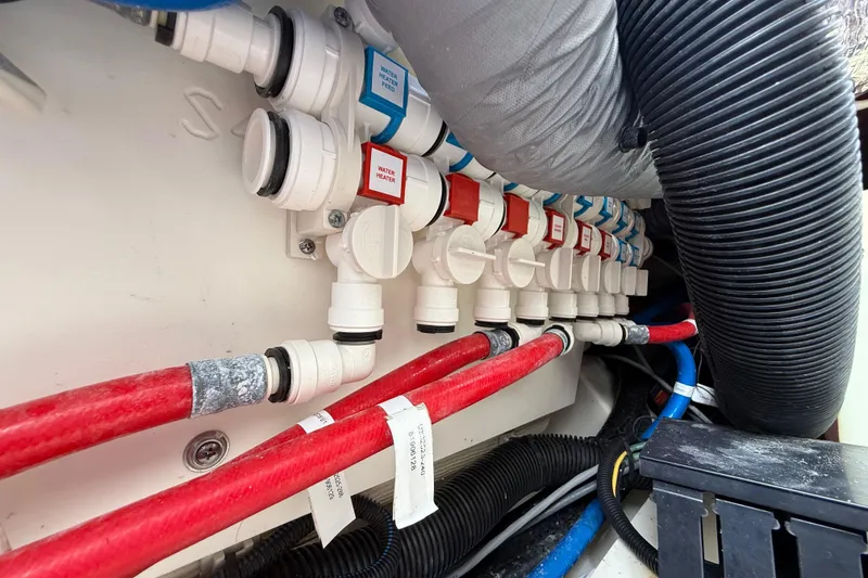 Slide: The Image of Boat plumbing system with labeled valves and hoses in a 2022 Pursuit S 358 Sport. - 119