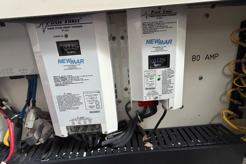 Slide: The Image of Electrical panel with Newmar Phase Three smart chargers, 80 AMP, in a 2022 Pursuit S 358 Sport. - 122