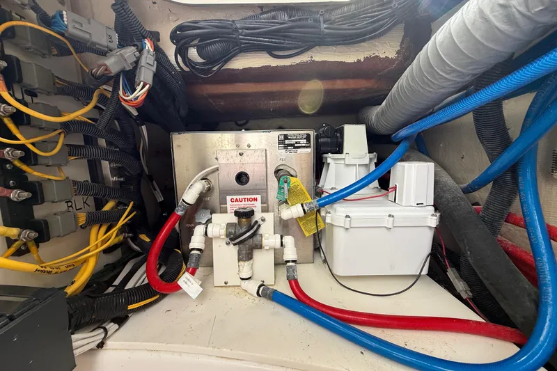 Slide: The Image of Electrical and plumbing system inside 2022 Pursuit S 358 Sport boat. - 126