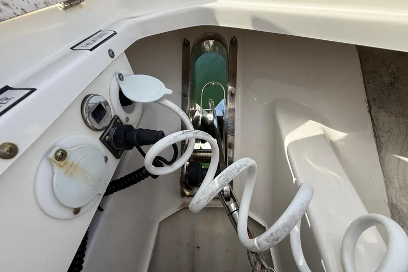 Slide: The Image of 2022 Pursuit S 358 Sport boat interior with coiled cables and control panel. - 131