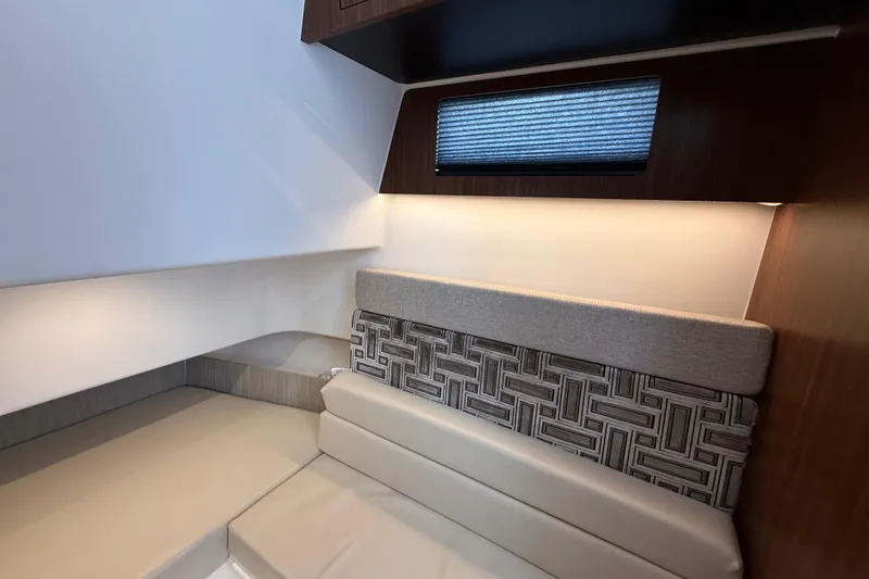 Slide: The Image of Interior cabin of 2022 Pursuit S 358 Sport boat, featuring modern seating and lighting. - 138