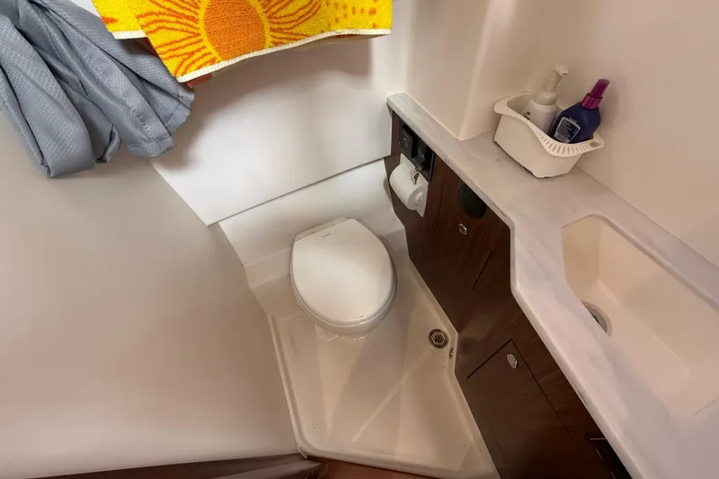 Slide: The Image of 2022 Pursuit S 358 Sport boat bathroom with toilet, sink, and storage. - 144