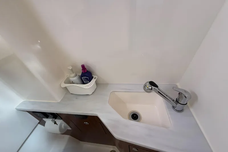 Slide: The Image of 2022 Pursuit S 358 Sport boat bathroom sink with faucet and toiletries. - 147
