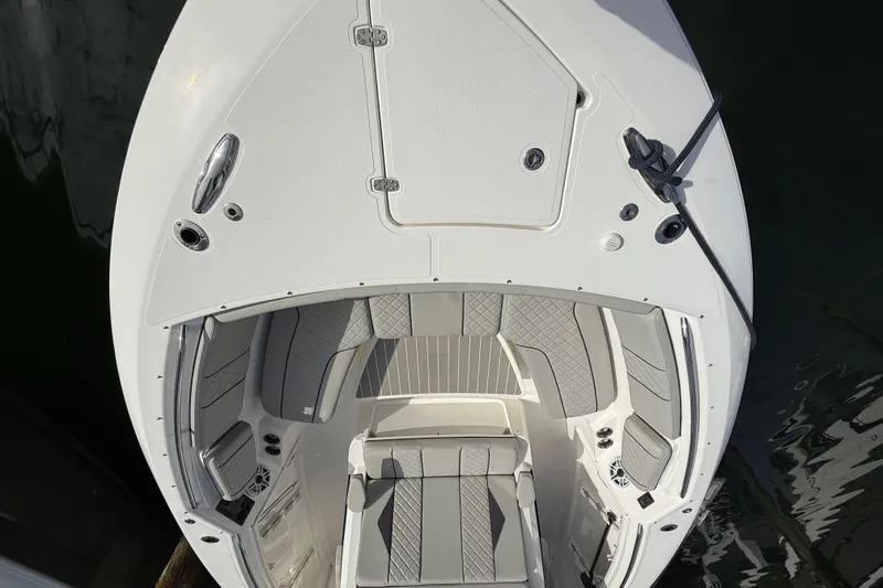 Slide: The Image of 2022 Pursuit S 358 Sport boat, top view of bow seating area with gray upholstery. - 22