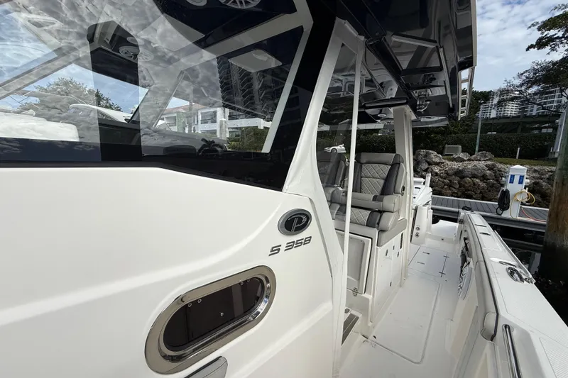 Slide: The Image of 2022 Pursuit S 358 Sport boat, sleek design, docked with luxurious seating. - 36
