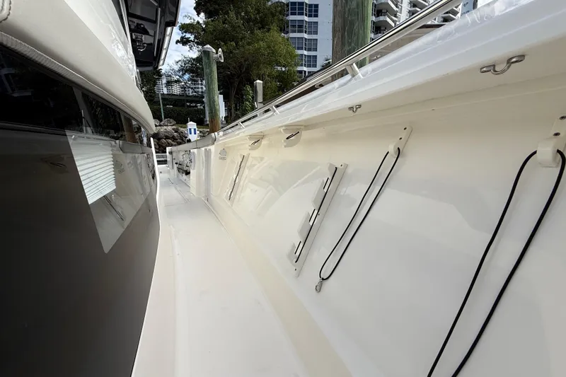 Slide: The Image of 2022 Pursuit S 358 Sport boat docked, showcasing sleek side view and modern design. - 41