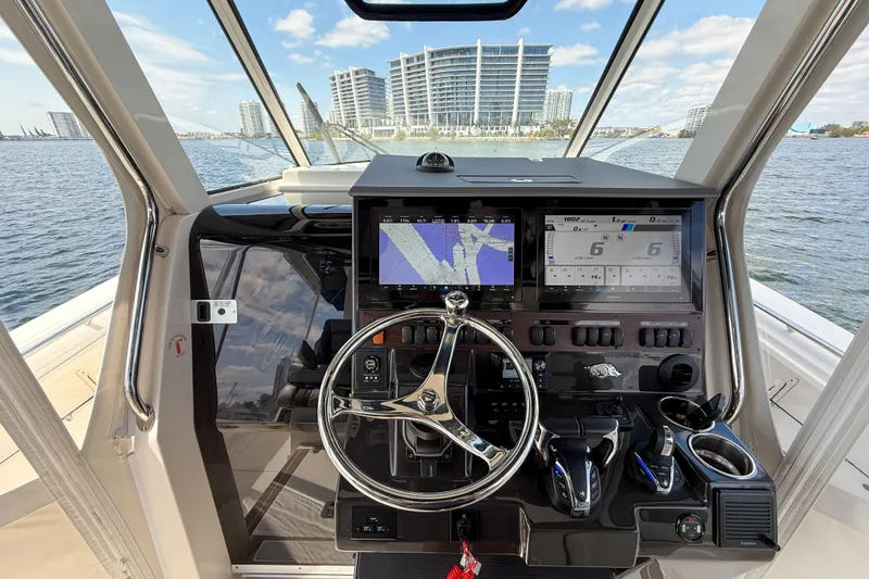 Slide: The Image of Interior of 2022 Pursuit S 358 Sport boat with luxurious seating and advanced controls. - 5