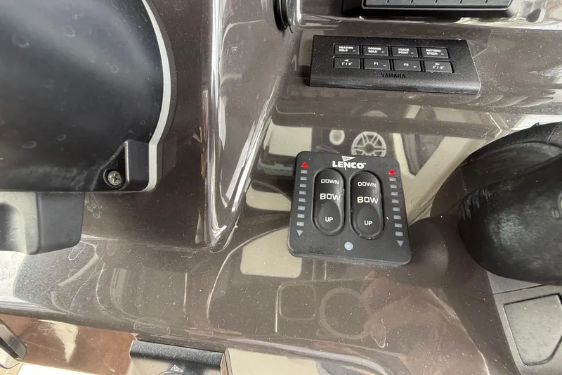 Slide: The Image of Control panel of 2022 Pursuit S 358 Sport boat with Lenco trim tab switches. - 60