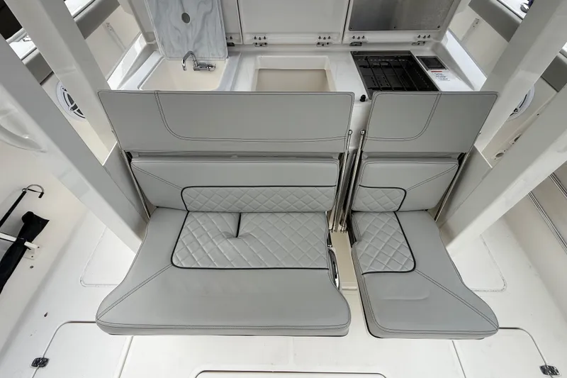 Slide: The Image of 2022 Pursuit S 358 Sport boat interior with foldable seats and kitchenette. - 66