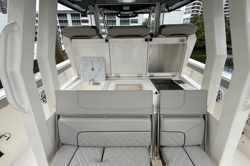 Slide: The Image of 2022 Pursuit S 358 Sport boat interior with seating and kitchenette area. - 67