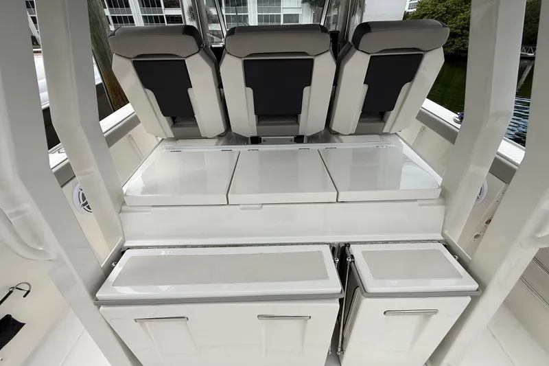 Slide: The Image of 2022 Pursuit S 358 Sport boat interior with sleek seating and storage compartments. - 73