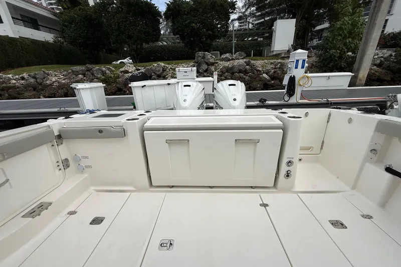 Slide: The Image of 2022 Pursuit S 358 Sport boat interior with storage compartments and seating. - 76