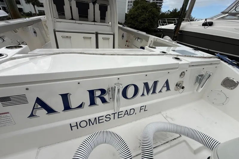 Slide: The Image of 2022 Pursuit S 358 Sport boat docked, featuring "ALRIOMA" and "Homestead, FL" on the stern. - 89