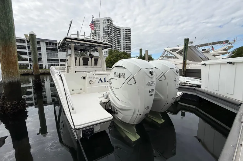 Slide: The Image of 2022 Pursuit S 358 Sport boat with twin Yamaha 425 V8 engines docked in marina. - 92