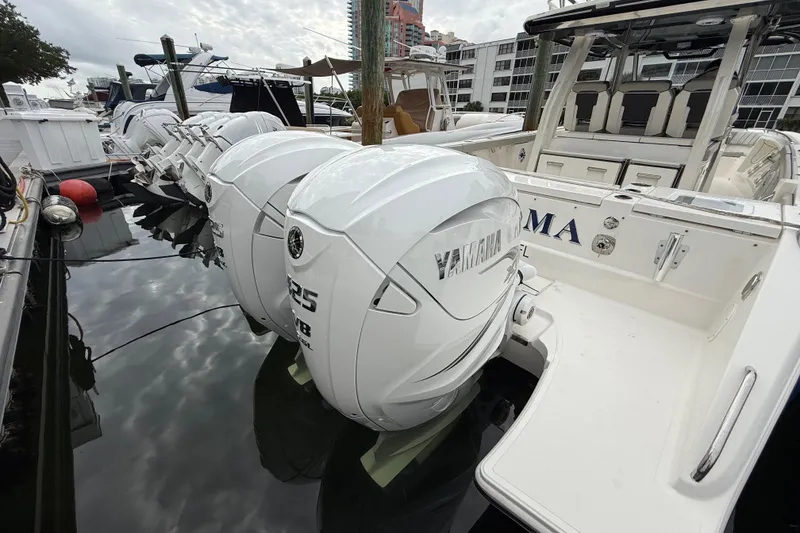 Slide: The Image of 2022 Pursuit S 358 Sport boat with twin Yamaha 425 engines docked at marina. - 93