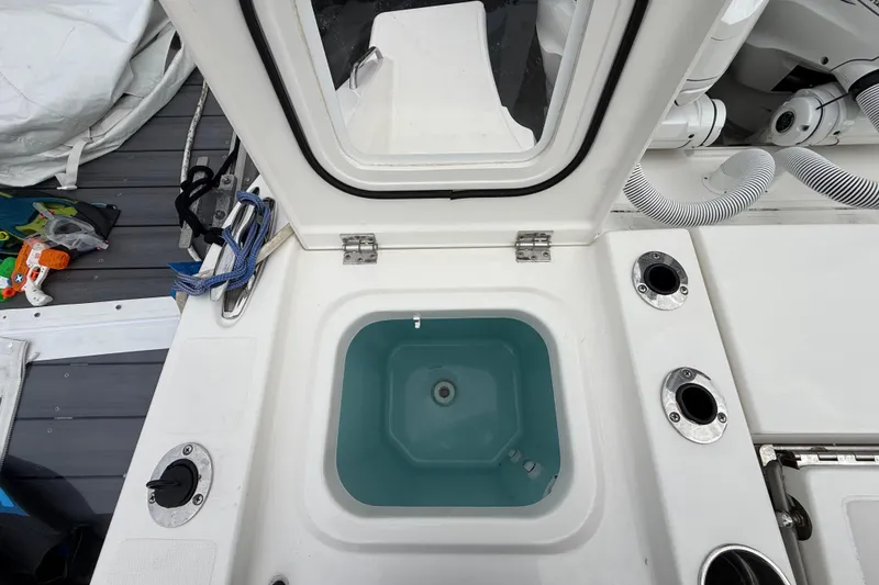 Slide: The Image of 2022 Pursuit S 358 Sport boat livewell with open lid and accessories. - 96