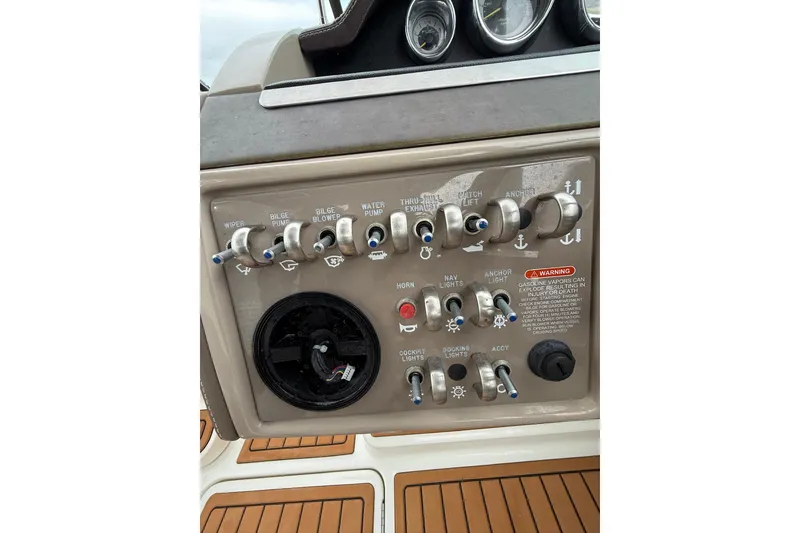Slide: The Image of Control panel of a 2011 Sea Ray 250 SLX boat with various switches and gauges. - 16