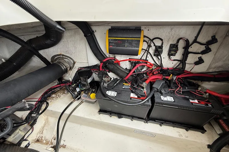 Slide: The Image of Engine compartment of a 2011 Sea Ray 250 SLX with batteries and wiring. - 20