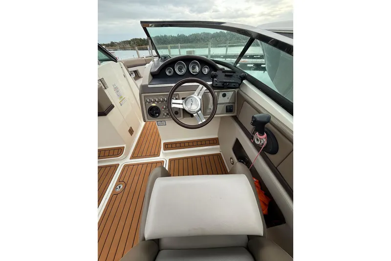 Slide: The Image of 2011 Sea Ray 250 SLX boat interior with steering wheel and dashboard controls. - 22
