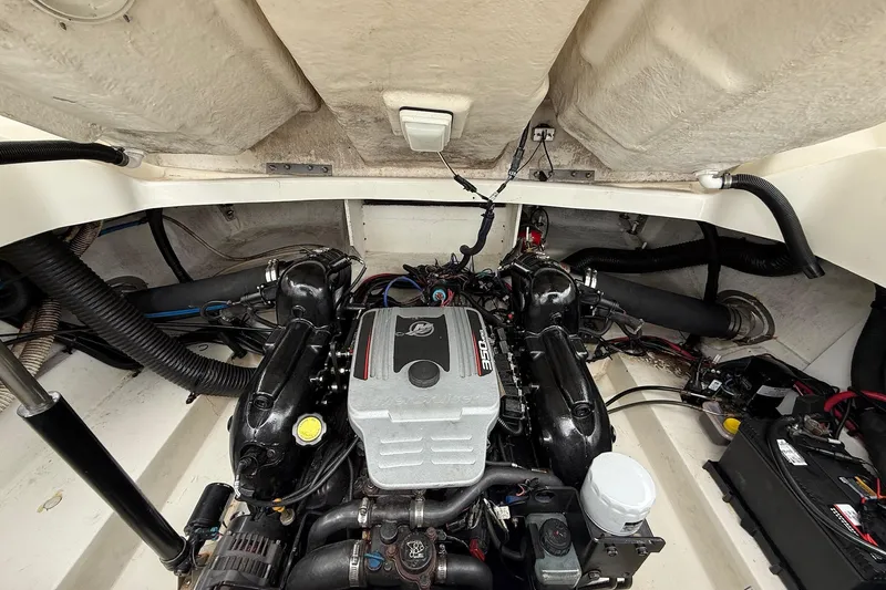 Slide: The Image of Engine compartment of a 2011 Sea Ray 250 SLX boat, showcasing the engine and components. - 24