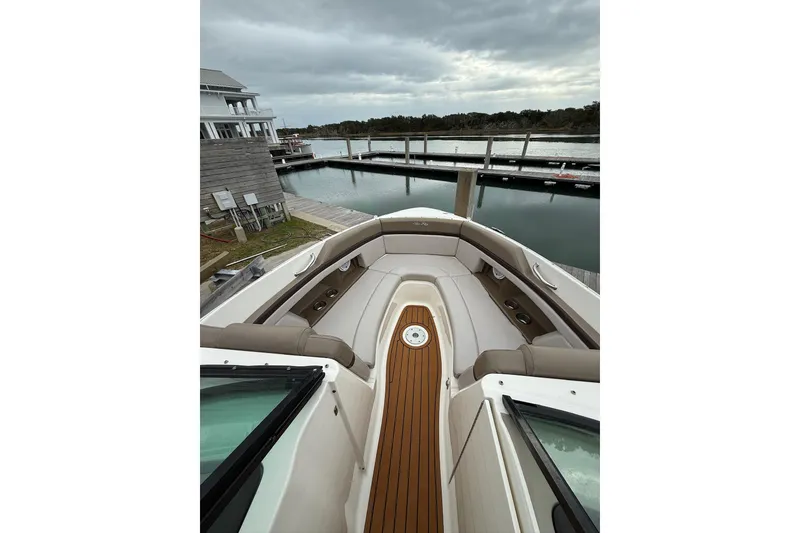 Slide: The Image of 2011 Sea Ray 250 SLX boat docked, featuring spacious seating and elegant design. - 3
