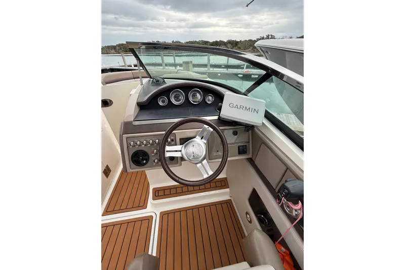 Slide: The Image of Interior view of 2011 Sea Ray 250 SLX boat with Garmin navigation system. - 4