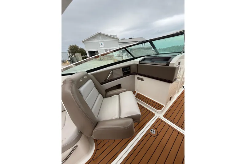 Slide: The Image of 2011 Sea Ray 250 SLX boat interior with brown leather seating and wood flooring. - 5