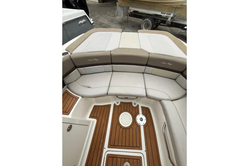 Slide: The Image of 2011 Sea Ray 250 SLX boat interior with cushioned seating and teak flooring. - 7