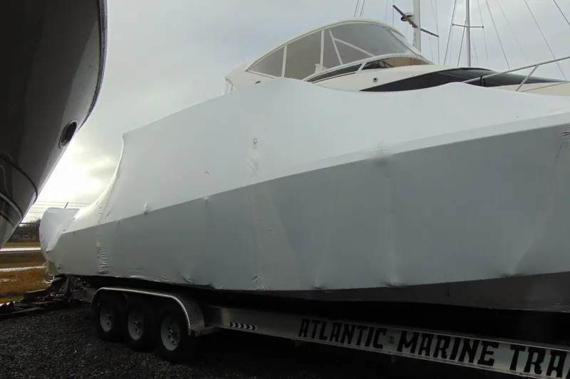 Slide: The Image of 2023 Nor-Tech 390 Sport Center Console boat covered on trailer. - 10